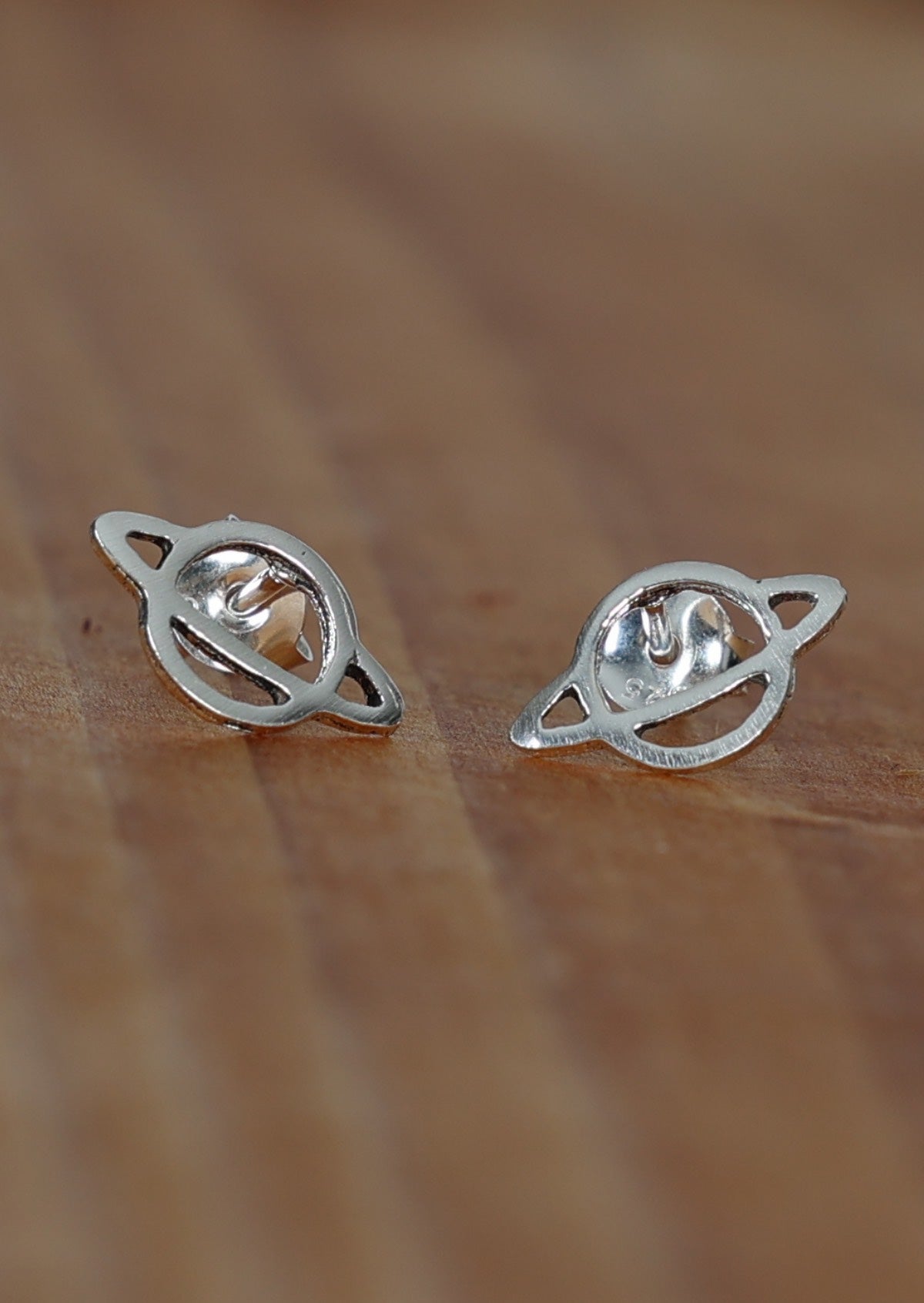Sterling silver Saturn cutout design stud earrings with butterfly backs