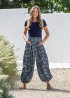Model wears cotton harem pants with elasticated ankles, wide waistband and deep pockets.