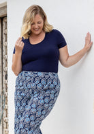 Woman wearing a scoop neck navy blue rayon fitted t-shirt.