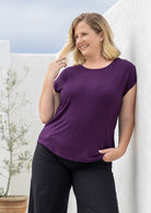 Woman wearing a soft flattering fit purple rayon jersey t-shirt.