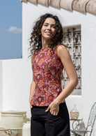 Woman wears a Japanese style print sleeveless cotton top with pink, maroon, brown, peach and khaki palette