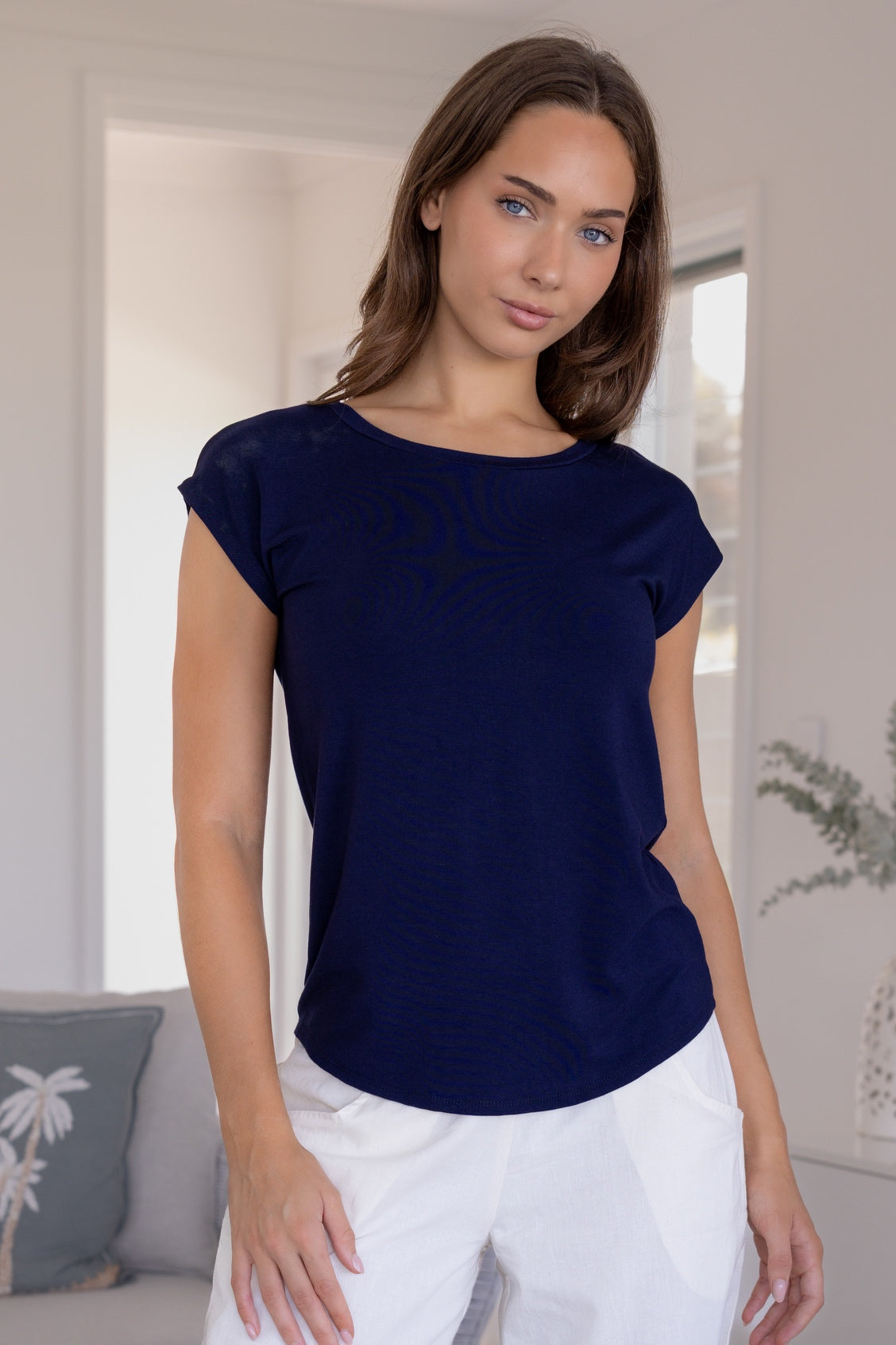 Woman wearing a navy blue soft stretch rayon jersey t-shirt with cap sleeves