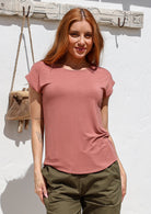 Woman wearing a soft flattering fit dusty pink rayon jersey t-shirt.