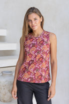 Woman wearing a sleeveless 100% cotton top with round neckline in warm toned Japanese style print