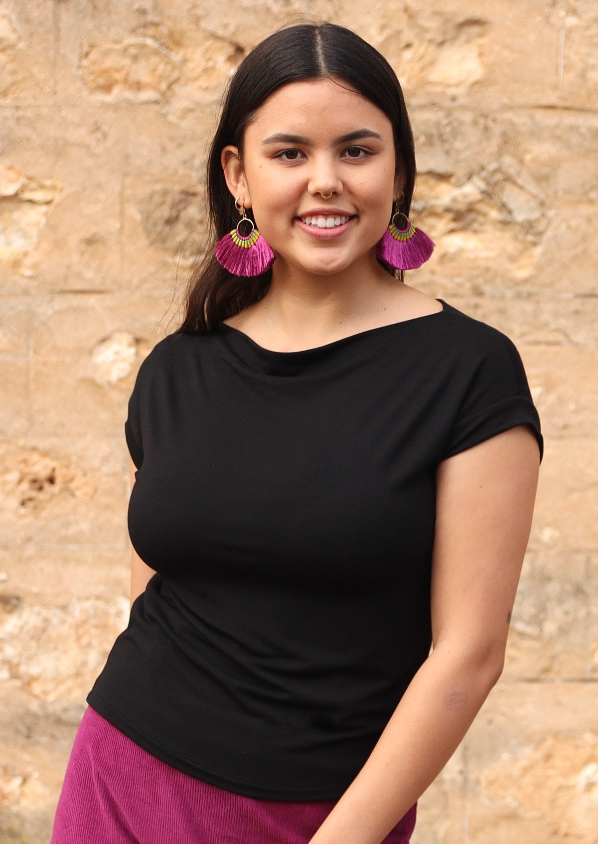 Woman wearing a wide neck mod black stretch rayon boat neck top