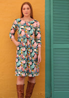 Women wears cotton dress with small gathers in relaxed waistline, 3/4 sleeves and pockets