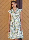 Woman wearing cream coloured cotton dress with floral print with capped sleeve