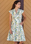 Woman wearing retro style cream coloured cotton dress with floral print