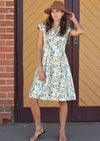 Woman wearing cream coloured 100 percent cotton dress with floral print