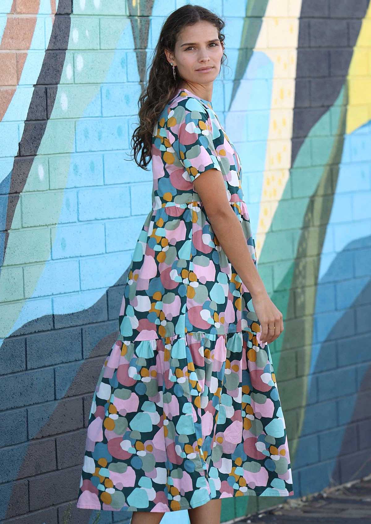women wearing tiered midlength dress with pastel coloured spots 
