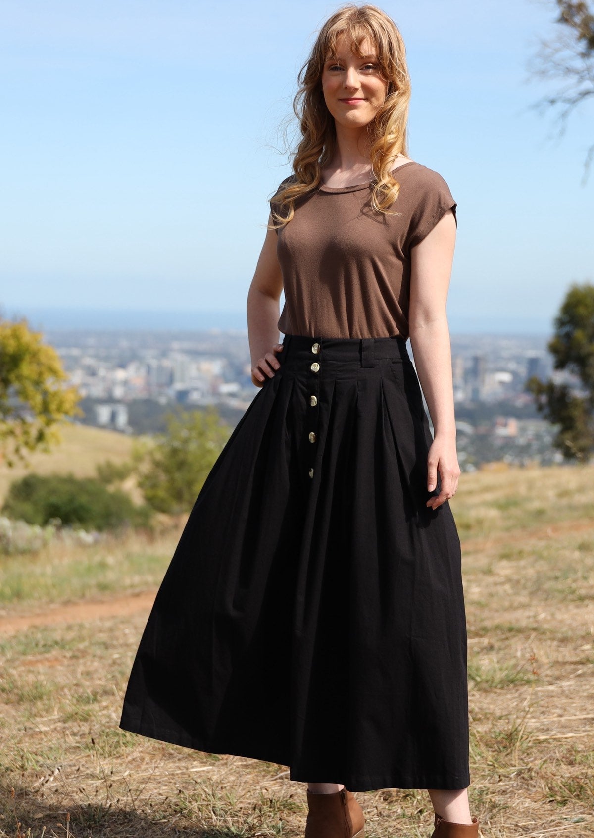 Belt loops and box pleat detailed midi length A-line black cotton skirt