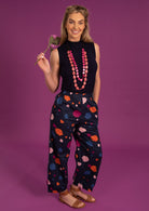 Greta Pants high waisted women's pants elasticated waistband side pockets pleats at side of ankles 100% cotton dark navy background coloured spot print| Karma East Australia