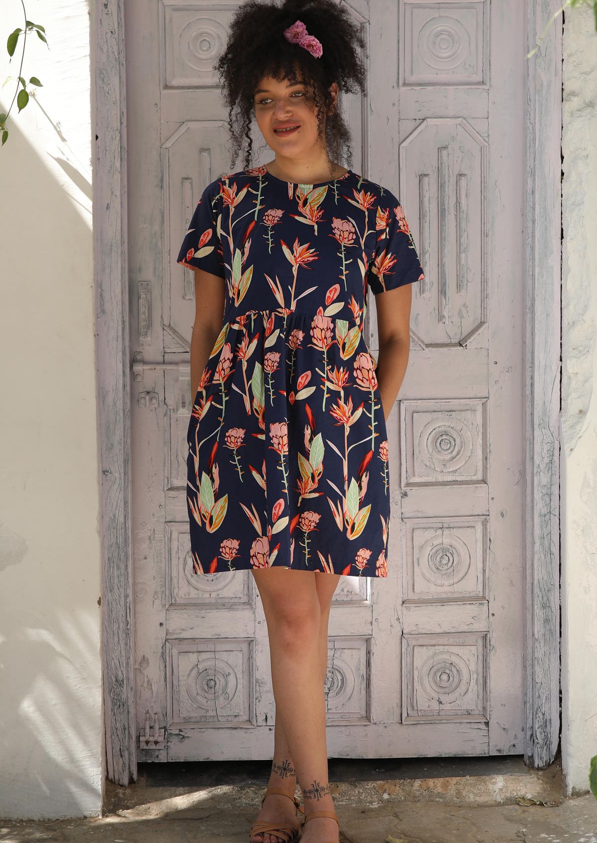 Woman Wearing above knee loose fit dress with pockets.