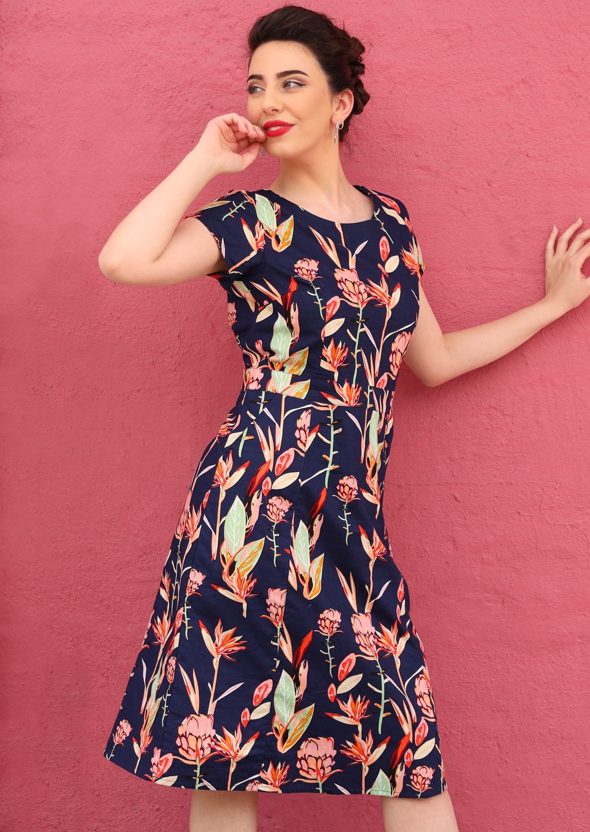 Woman wears round neck 100% cotton knee length dress with cap sleeves and pockets