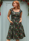 1950s Inspired Swing Womens Dress tailored bodice cap sleeve scoop neckline empire waistband flared a-line skirt below the knee length with pockets 100% cotton black background pink and green floral print | Karma East Australia
