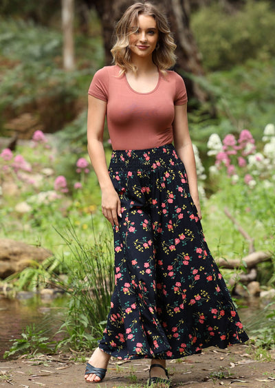 Umbrella Pant ultra wide leg elasticated, smocked waistband high-mid waist soft rayon dark navy background with green and pink floral print | Karma East Australia