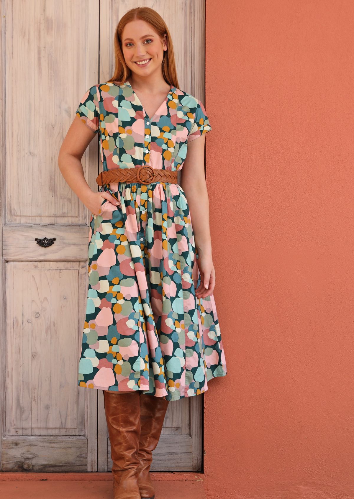 Model wears retro style Vivien dress with wide leather waist belt.