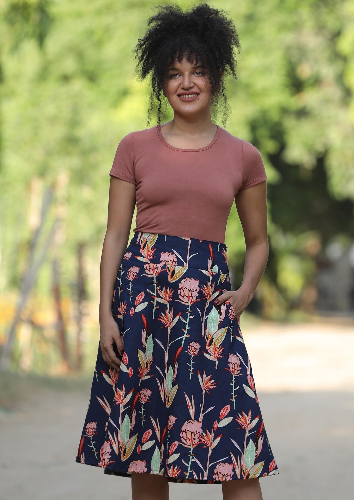 Model wears 100% cotton A line, below the knee length skirt with wide waistband and pockets.