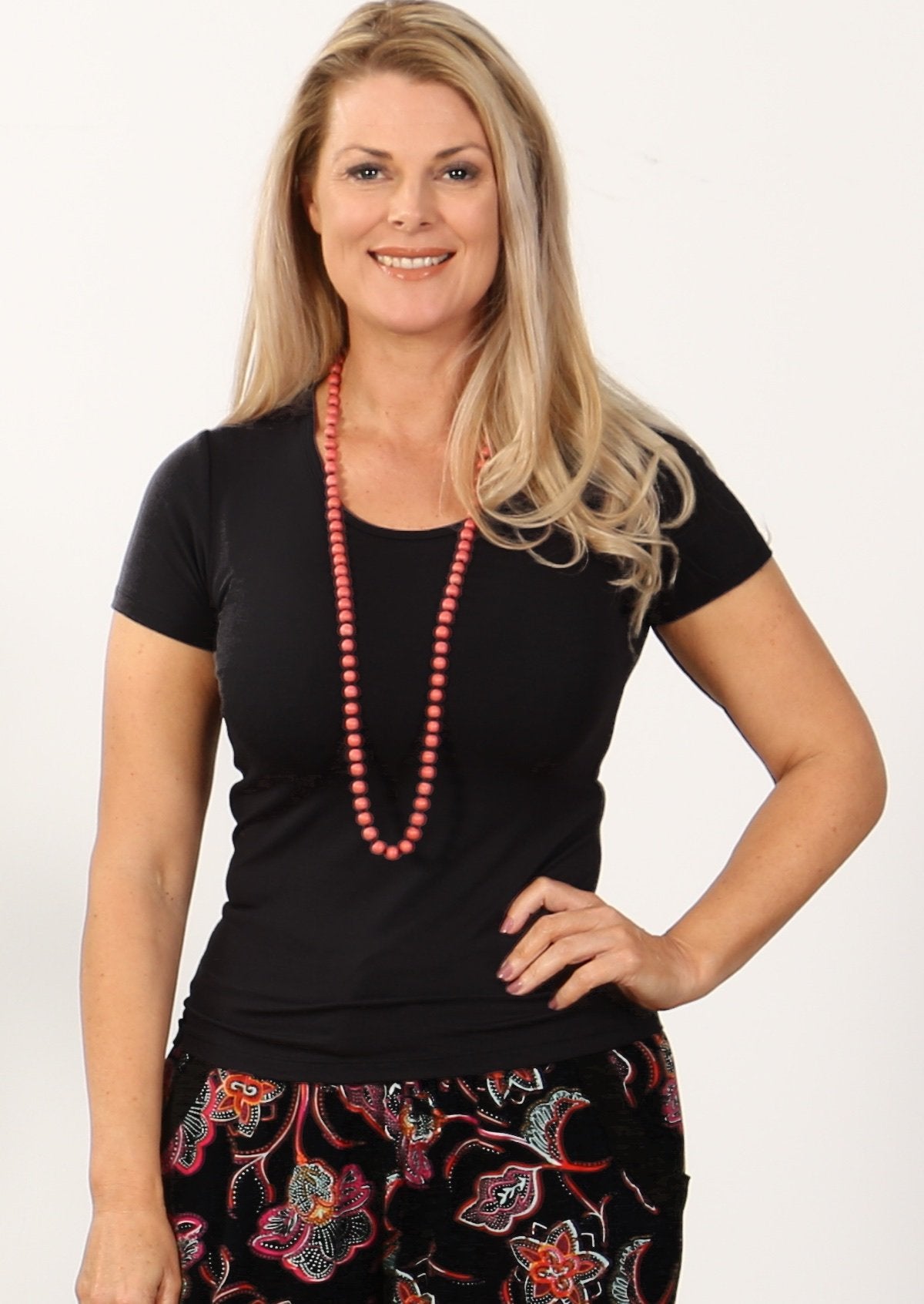 Woman with blonde hair wearing a black stretch rayon t-shirt.